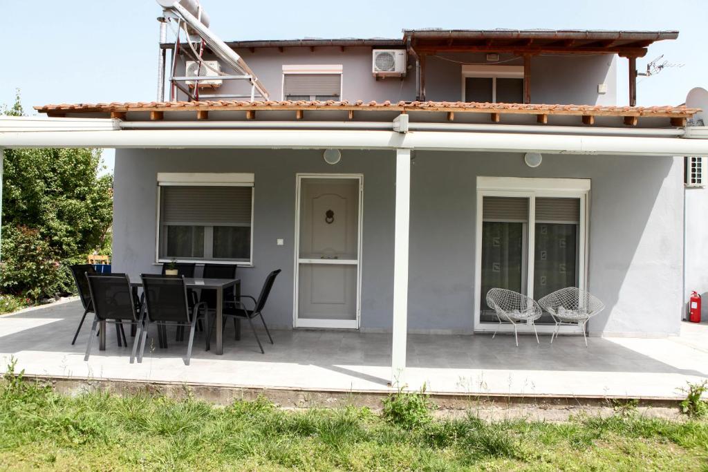 a patio with chairs and a table on a house at Nicole Fresh Apartments in Keramotí