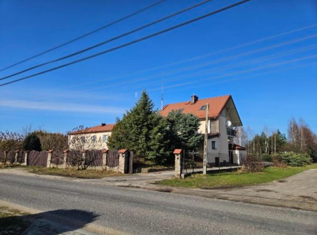 ein Haus am Straßenrand mit einer Straße in der Unterkunft Noclegi in Siestrzeń