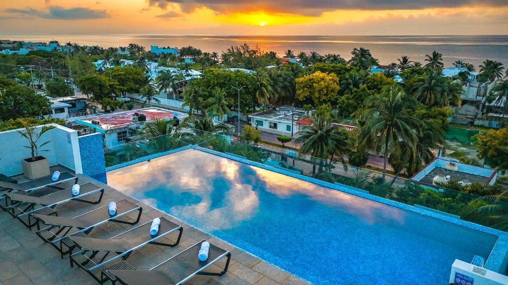 an image of a swimming pool with chairs at Areia Boutique Hotel - Puerto Morelos in Puerto Morelos