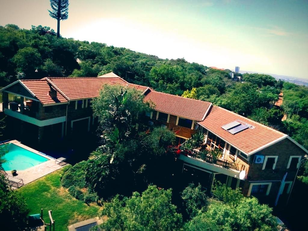 The swimming pool at or close to Cycad Place Midrand Guesthouse and B&B