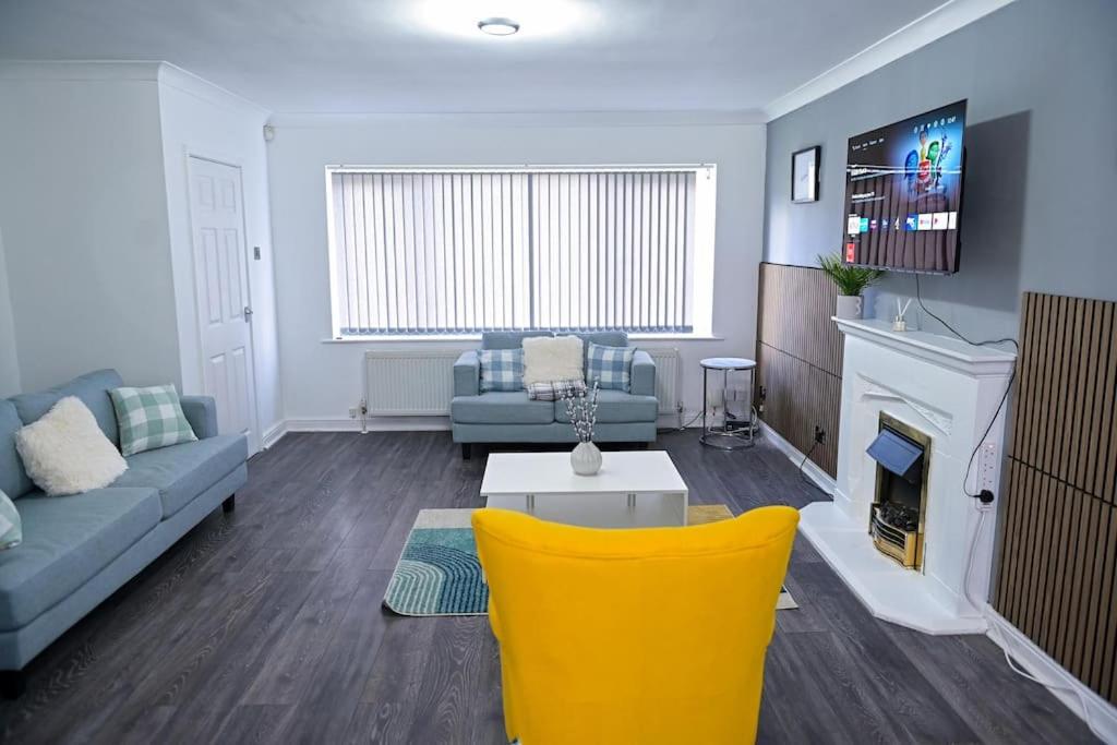 a living room with a couch and a fireplace at 3 Bedroom House Manchester Free Wifi and Parking in Manchester