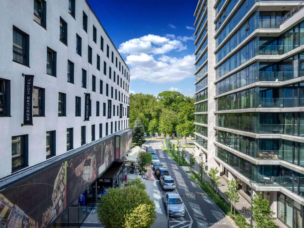 a view of a street between two tall buildings at Mercure Lublin Centrum in Lublin