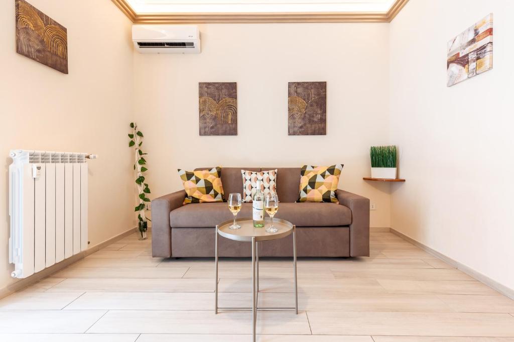 a living room with a couch and a table at Hostly- Don Bosco Light Lodge in Rome