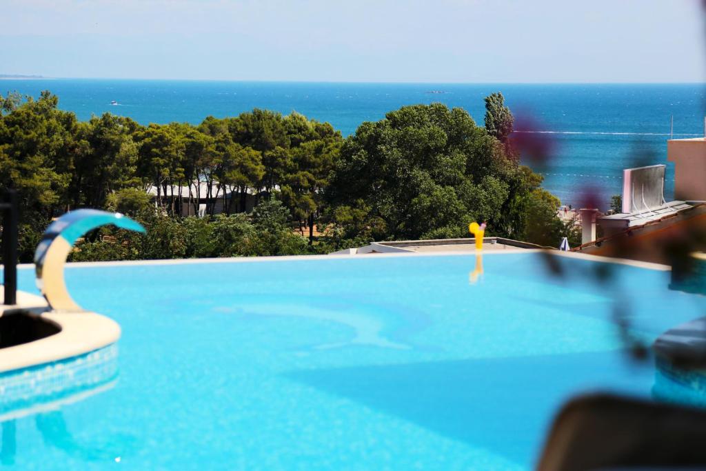 a swimming pool with a view of the ocean at Apartments Bazar in Ulcinj