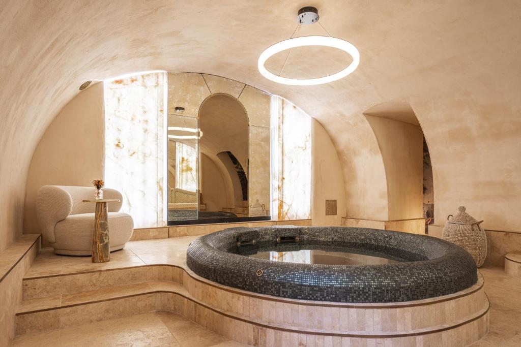 a large bathroom with a large tub in the middle at Hôtel Singulier Bordeaux - Boutique Hôtel & Spa Anne Semonin in Bordeaux