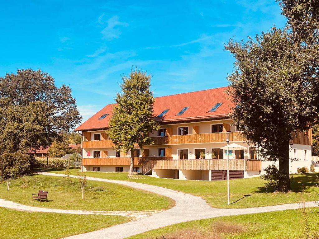 巴特比恩巴赫Chalet An der Brunnader - Ihr perfekter Rückzugsort in der Bayerischen Toskana的一座有红色屋顶和通道的建筑