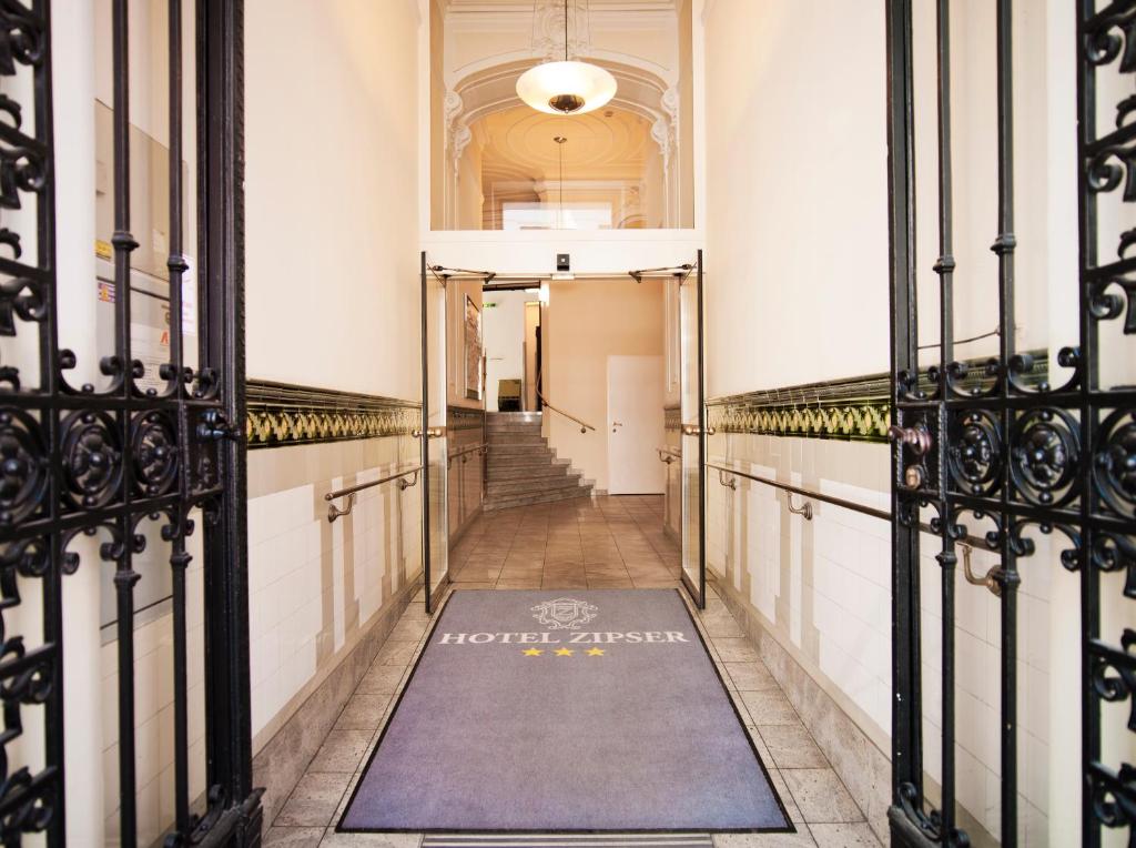 a hallway in a building with a gate at Hotel Zipser in Vienna