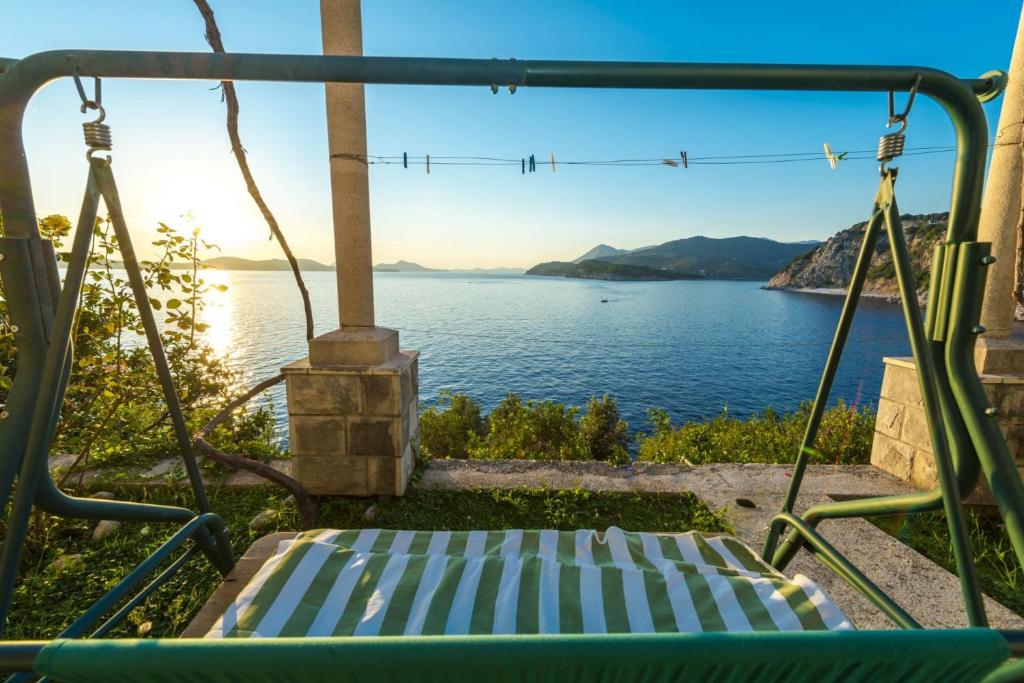 a swing with a view of the water at Apartments Dia in Dubrovnik