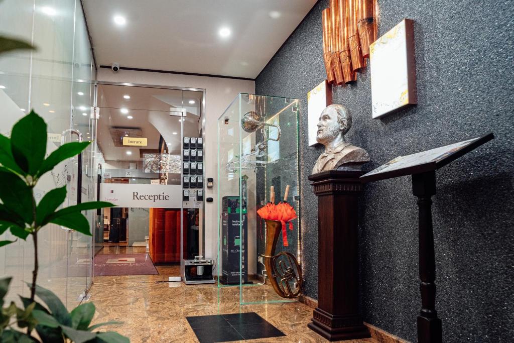 a statue of a man on a podium in a room at Villa & Restaurant Levoslav House in Sibiu