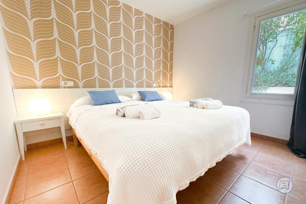 a bedroom with a bed with two towels on it at The Desmais in Cala Galdana