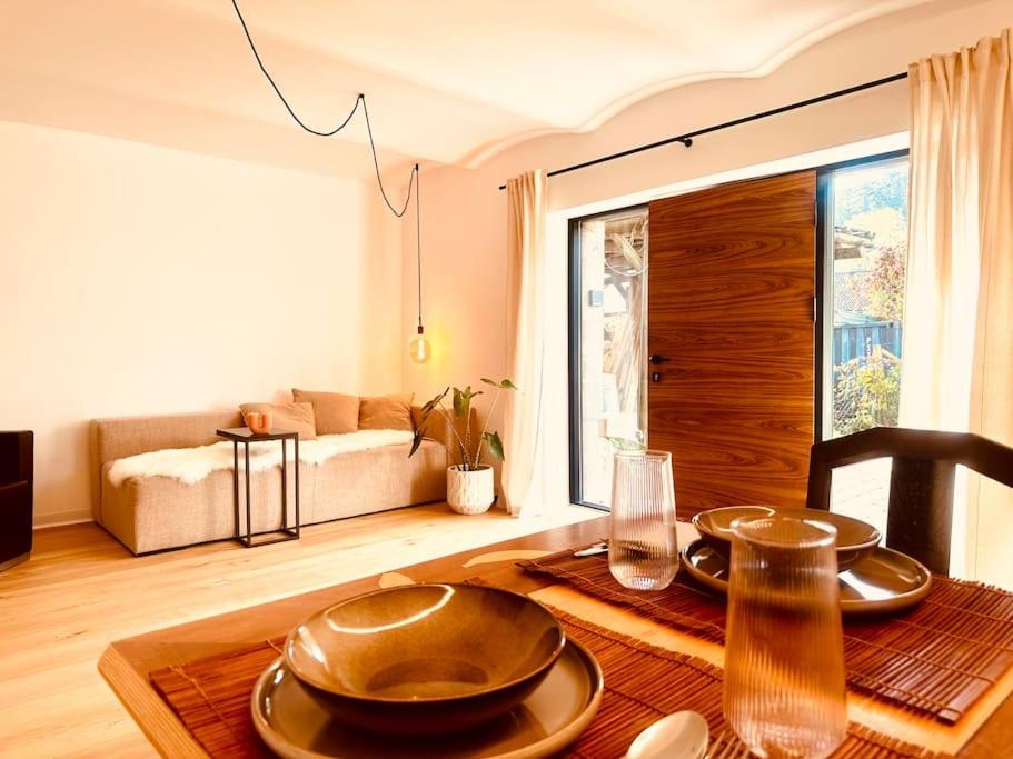 a dining room with a table and a couch at 2 Zimmer Apartment Sindelfingen Böblingen Calw in Aidlingen