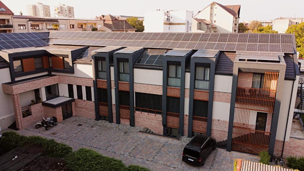 an image of a building with solar panels on it at No Pardon Hotel in Satu Mare