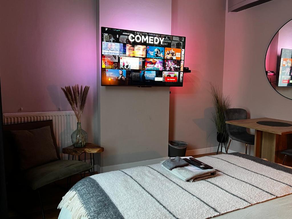 a bedroom with a bed and a tv on the wall at Escape in Leuven - self check in in Leuven