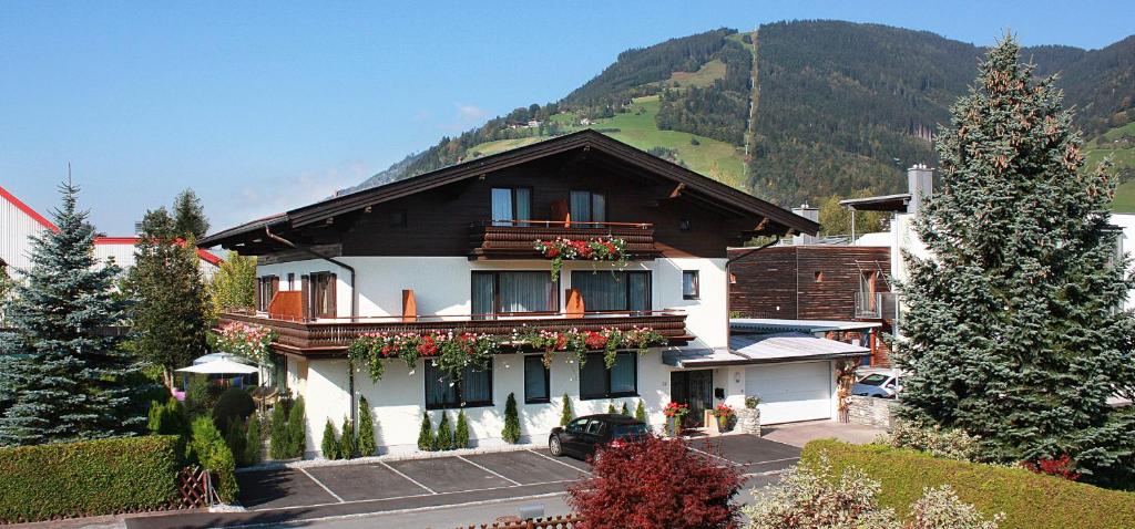 een huis met bloemen op het balkon bij Hotel Garni Landhaus Gitti in Zell am See