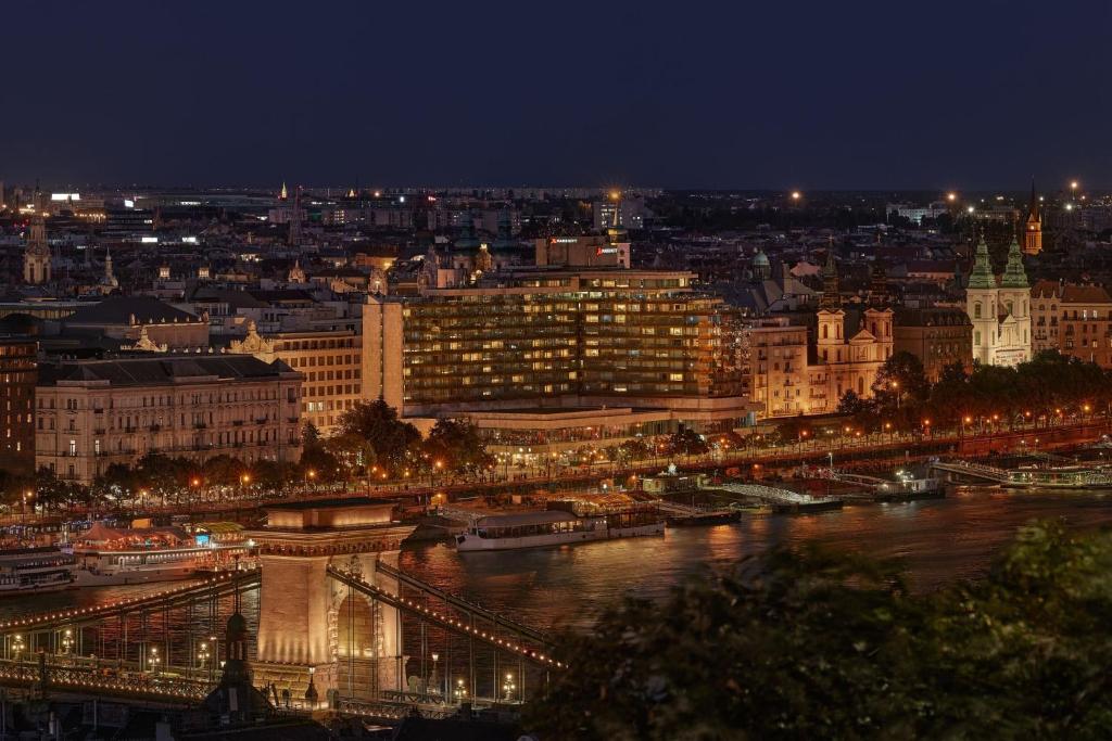 a view of a city at night with a river at Budapest Marriott Hotel in Budapest