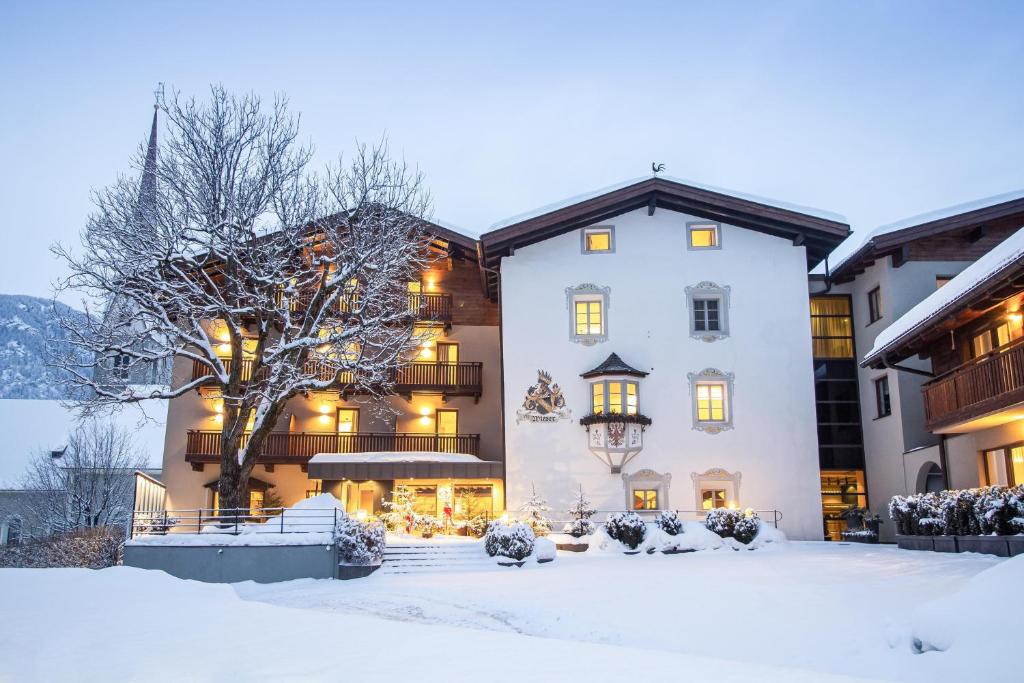 a large white building in the snow at Hotel Wieser in Campo di Trens