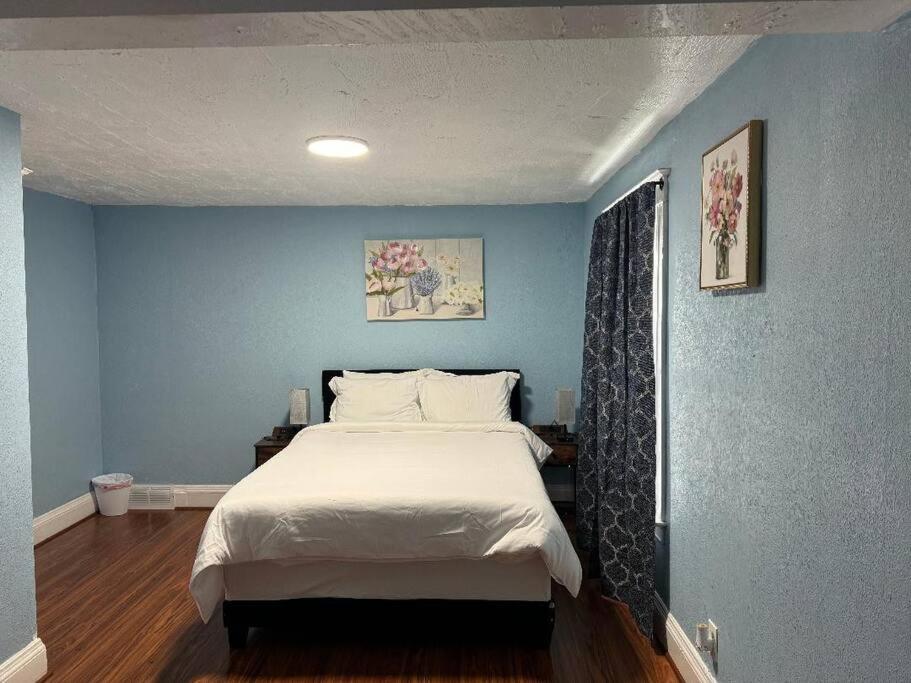 a bedroom with a large bed with blue walls at Getaway at Niagara in Niagara Falls