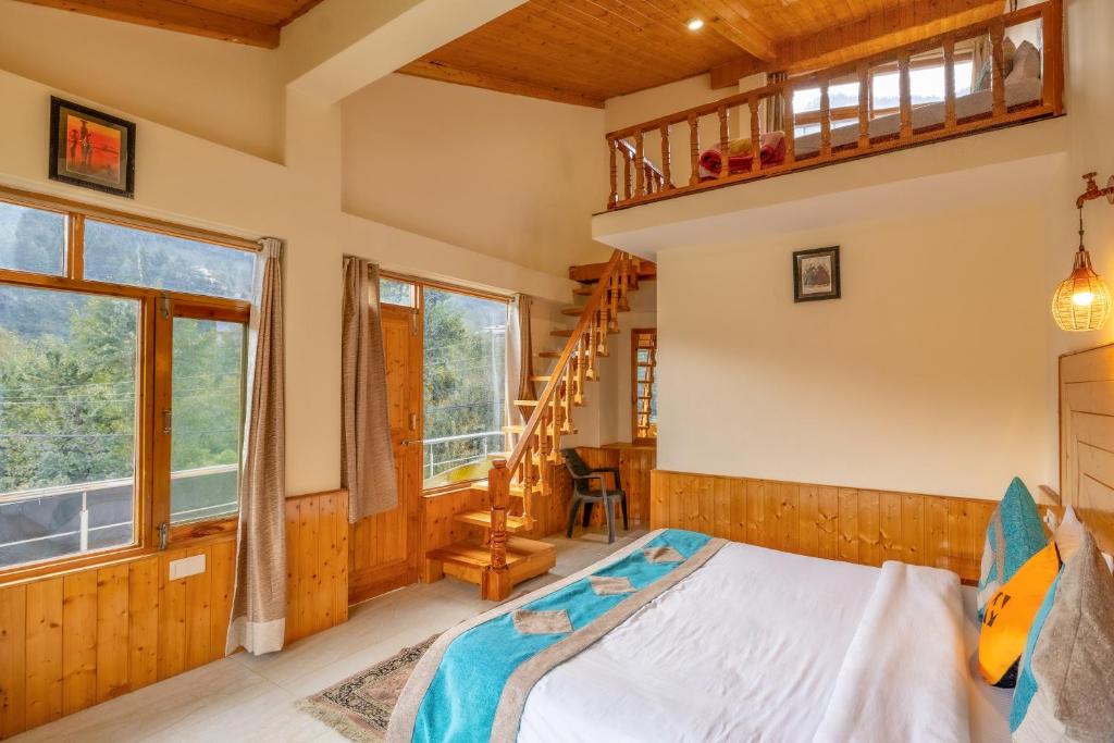 a bedroom with a bed and a ladder at Hide-in Old Manali in Manāli