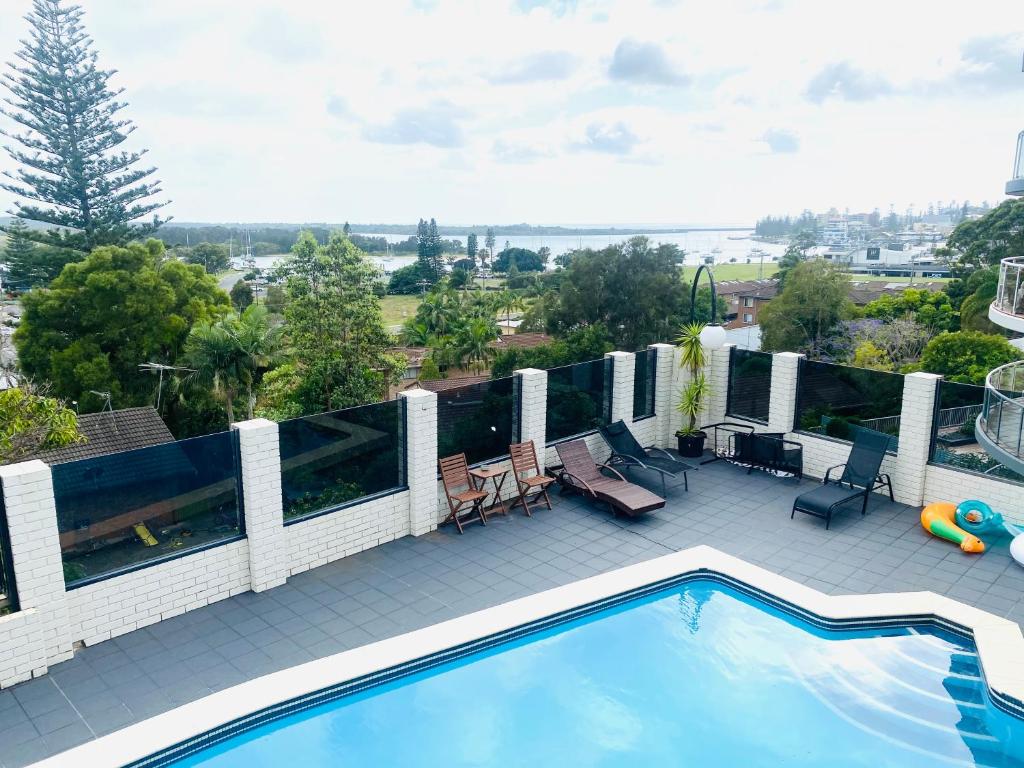 een balkon met uitzicht op een zwembad bij Citadel Suite in Port Macquarie