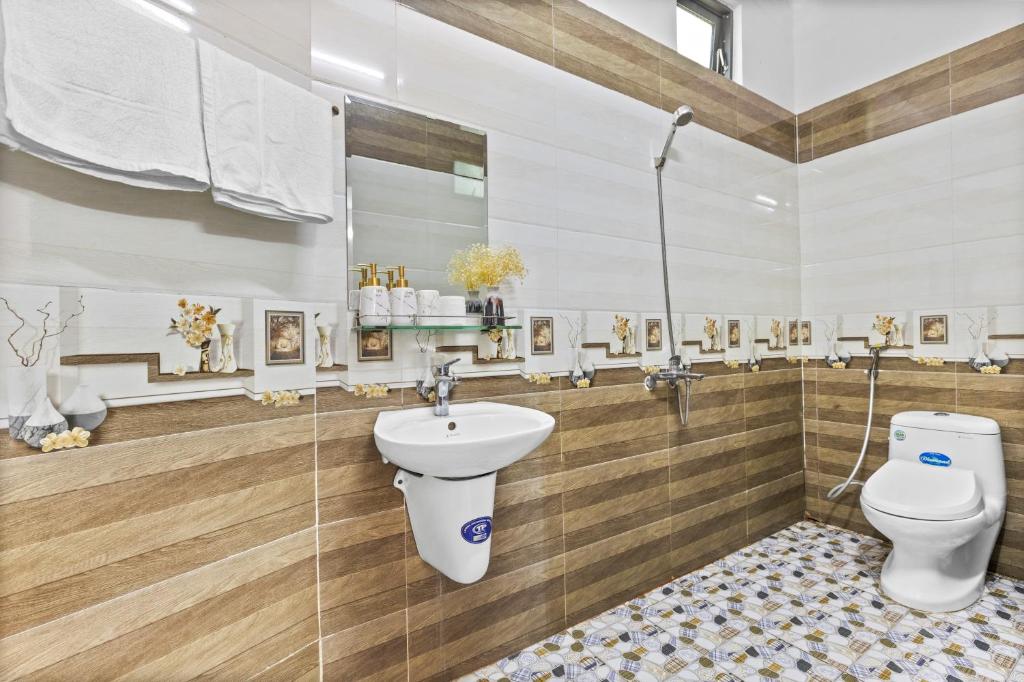 y baño con aseo y lavamanos. en Mộc Nhiên Hotel Da Nang, en Da Nang