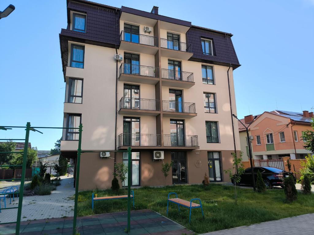 a large building with balconies on a street at Apartments Domovik Myru St. 11s/21 in Mukacheve