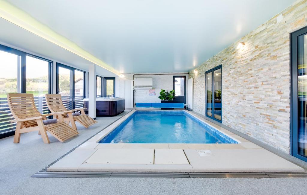 a swimming pool in a house with a brick wall at Relax house MAROKIS in Karlovac