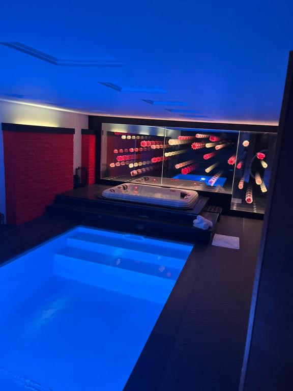 a bath tub in a room with blue lights at OCV Infiny in Durbuy