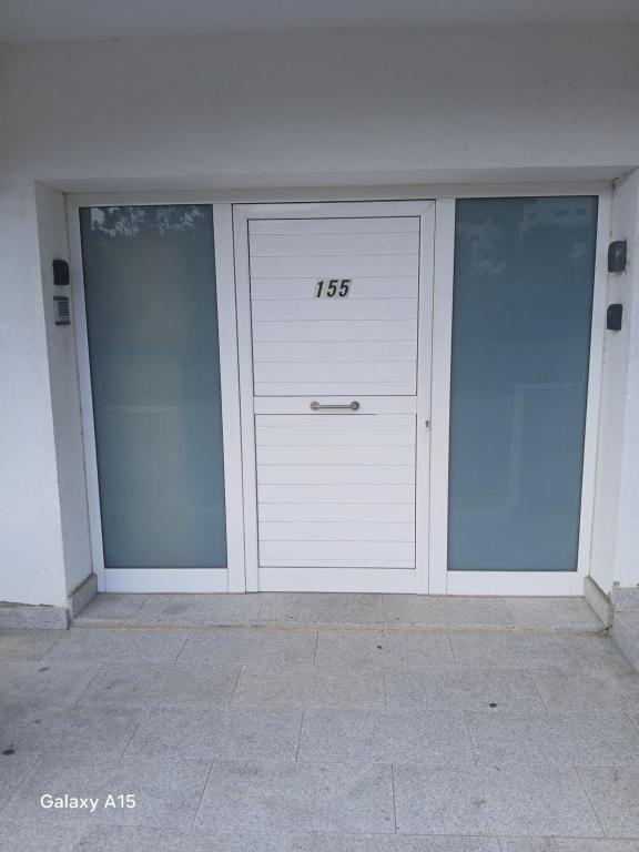 a building with two garage doors with numbers on it at Appartement Almadrava Roses in Roses