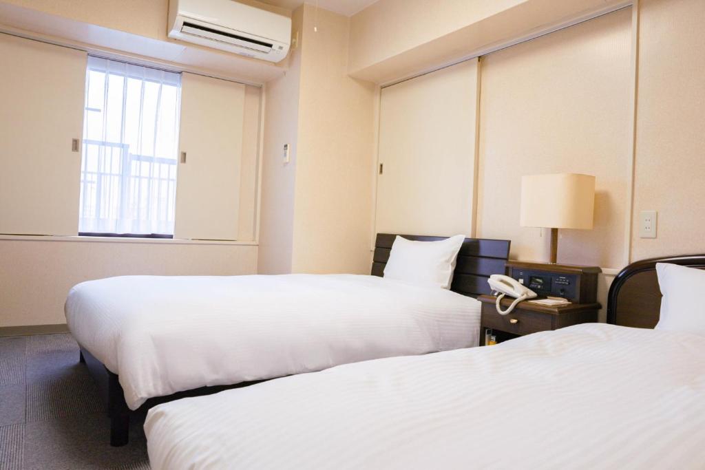 Tempat tidur dalam kamar di Hotel Alpha Inn Akita - Vacation STAY 67285v