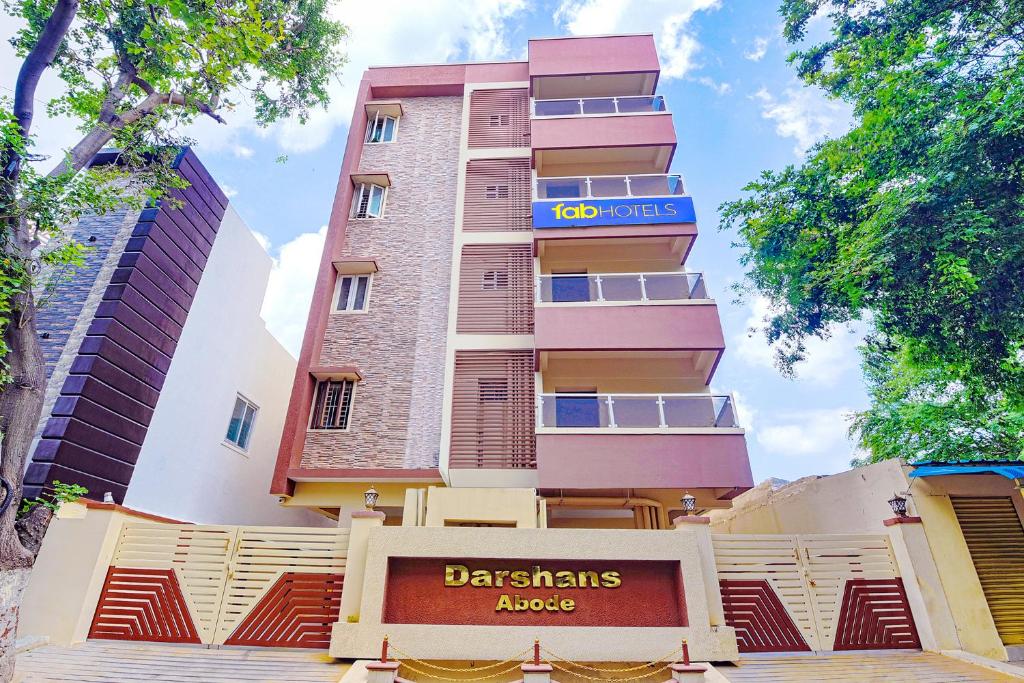 a tall building with a sign in front of it at FabHotel Darshan Adobe - Nr Bus stand in Coimbatore