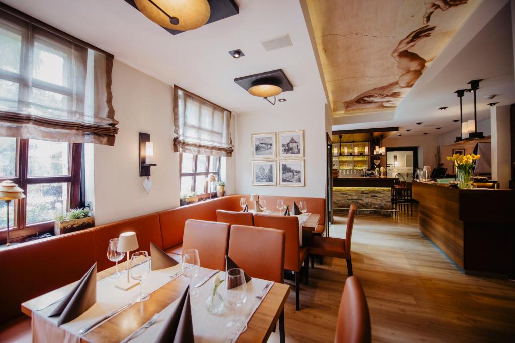 a restaurant with tables and chairs and a bar at Hotel-Restaurant Haselhoff in Coesfeld