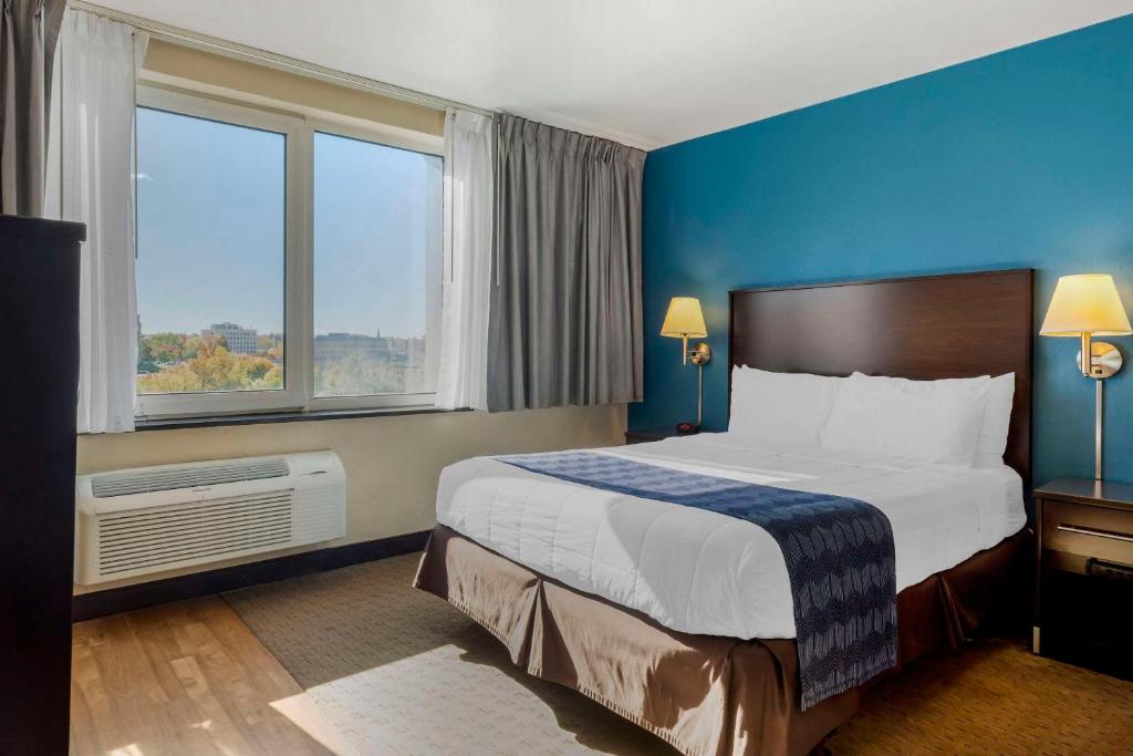 a hotel room with a bed and a large window at The Capitol Hotel, Ascend Hotel Collection in Hartford