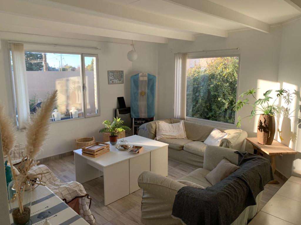 a living room with a couch and a table at Casa Amonite Hostel Boutique in Puerto Madryn