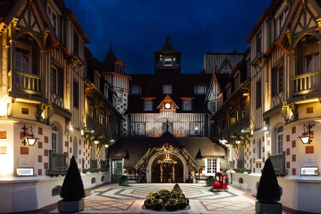 un gran edificio con un árbol de Navidad en un patio en Hôtel Barrière Le Normandy, en Deauville