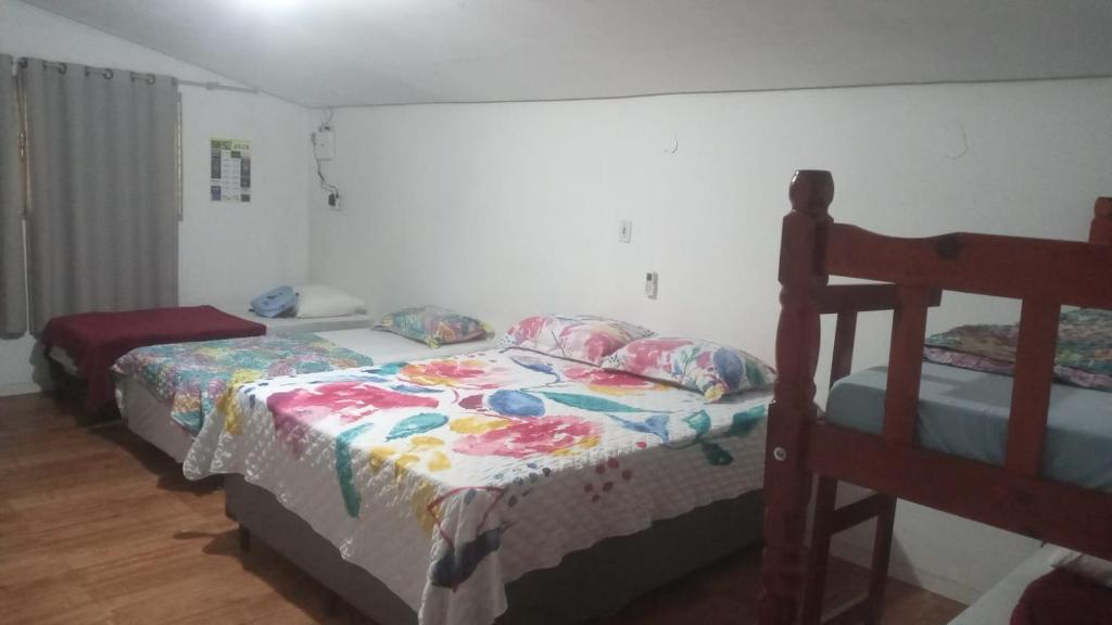 A bed or beds in a room at Oncotô Palmas Hostel