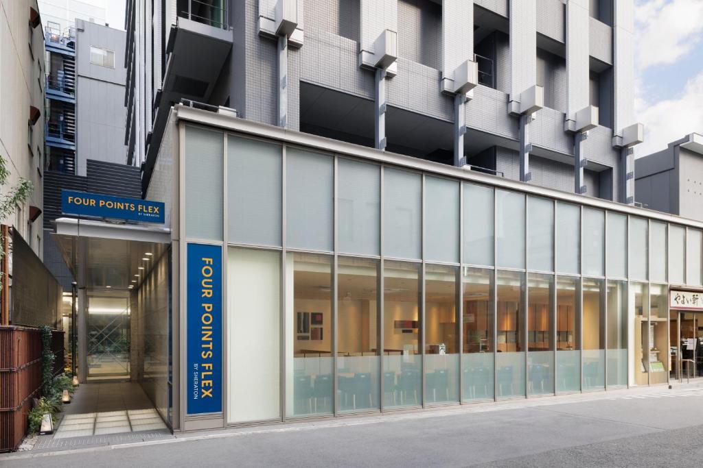 an external view of a building with glass windows at Four Points Flex by Sheraton Osaka Umeda in Osaka