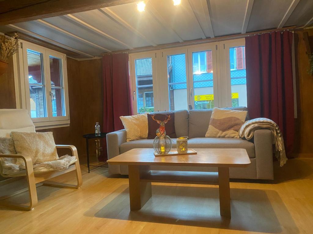 a living room with a couch and a coffee table at Cosy apartment in heritage protected swiss chalet in Matten