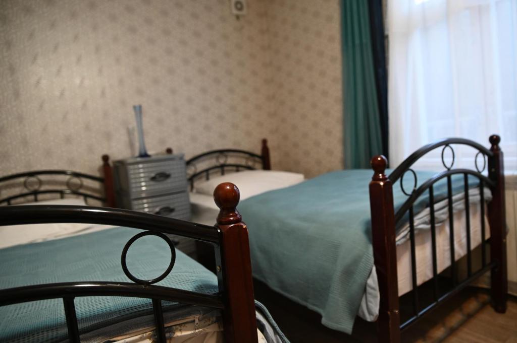 a bedroom with two bunk beds and a television at Babulya House in Gyumri