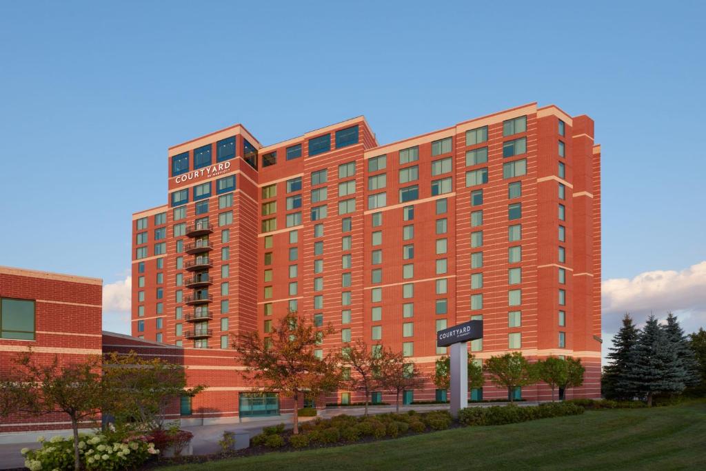 un grand bâtiment rouge avec un panneau devant lui dans l'établissement Courtyard by Marriott Ottawa East, à Ottawa