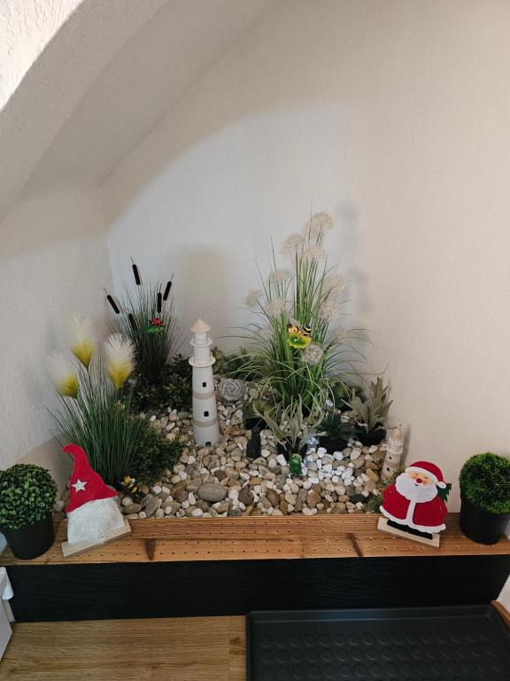 a shelf with plants and santa claus decorations on it at Natalia in Leoben