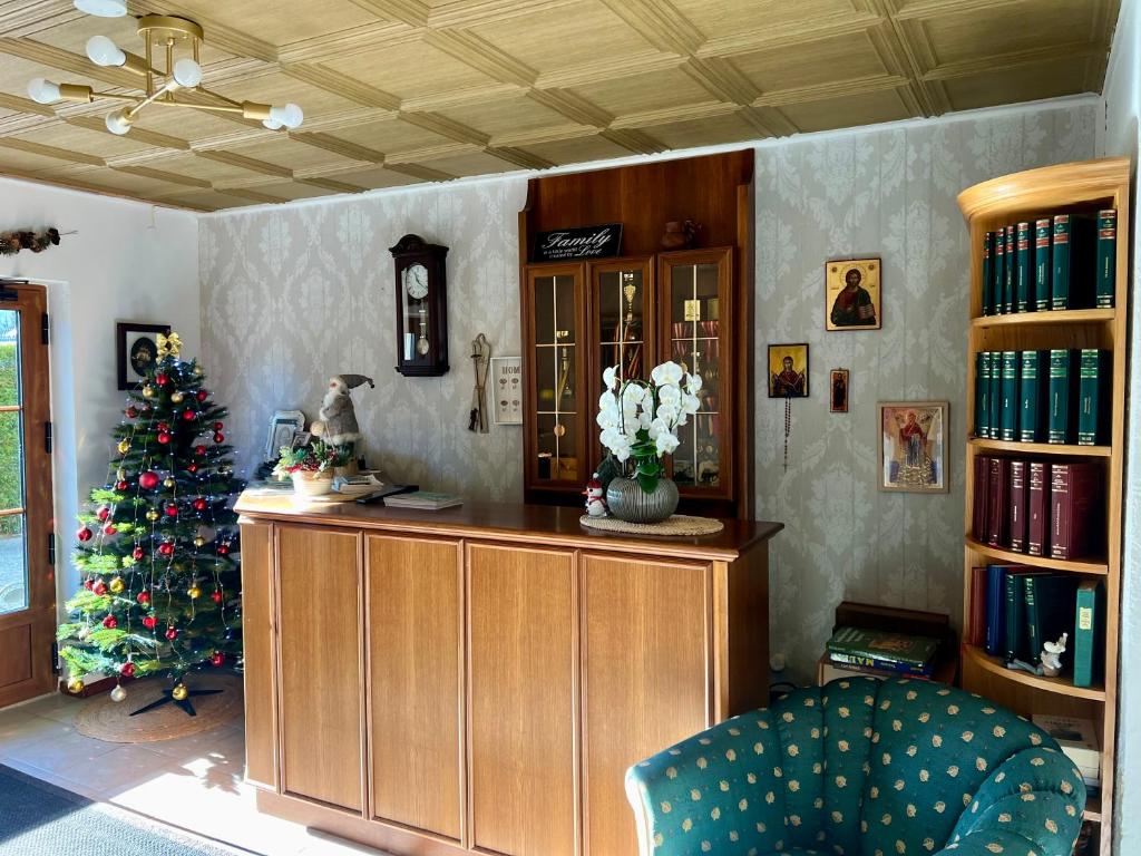 a living room with a christmas tree and a desk at Tannenhof in Semmering