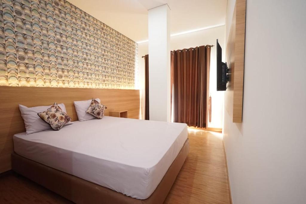 Ліжко або ліжка в номері SENAYAN SUITES