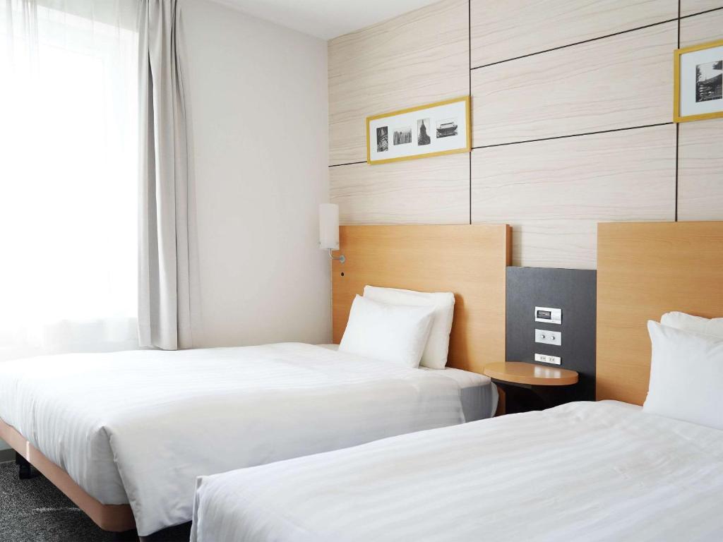 Llit o llits en una habitació de Comfort Hotel Tokyo Higashi Nihombashi