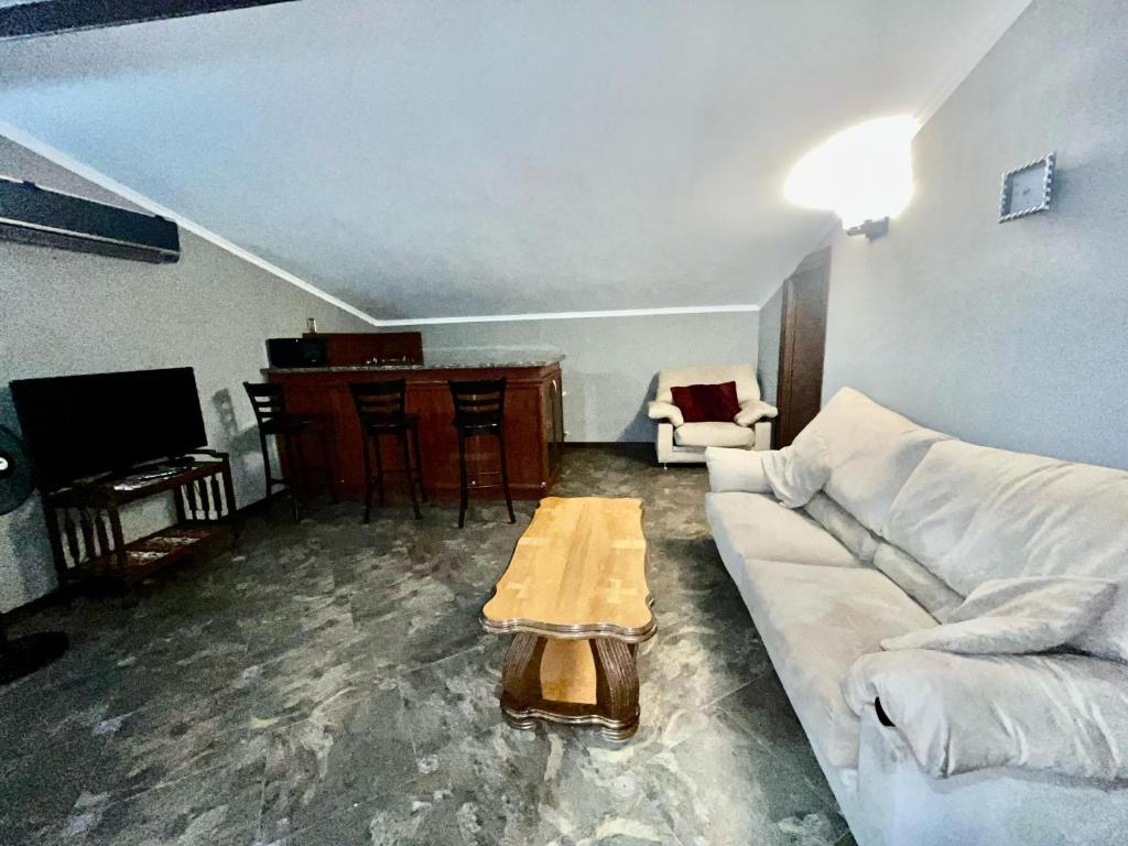 a living room with a white couch and a table at Anastasia in Mtskheta