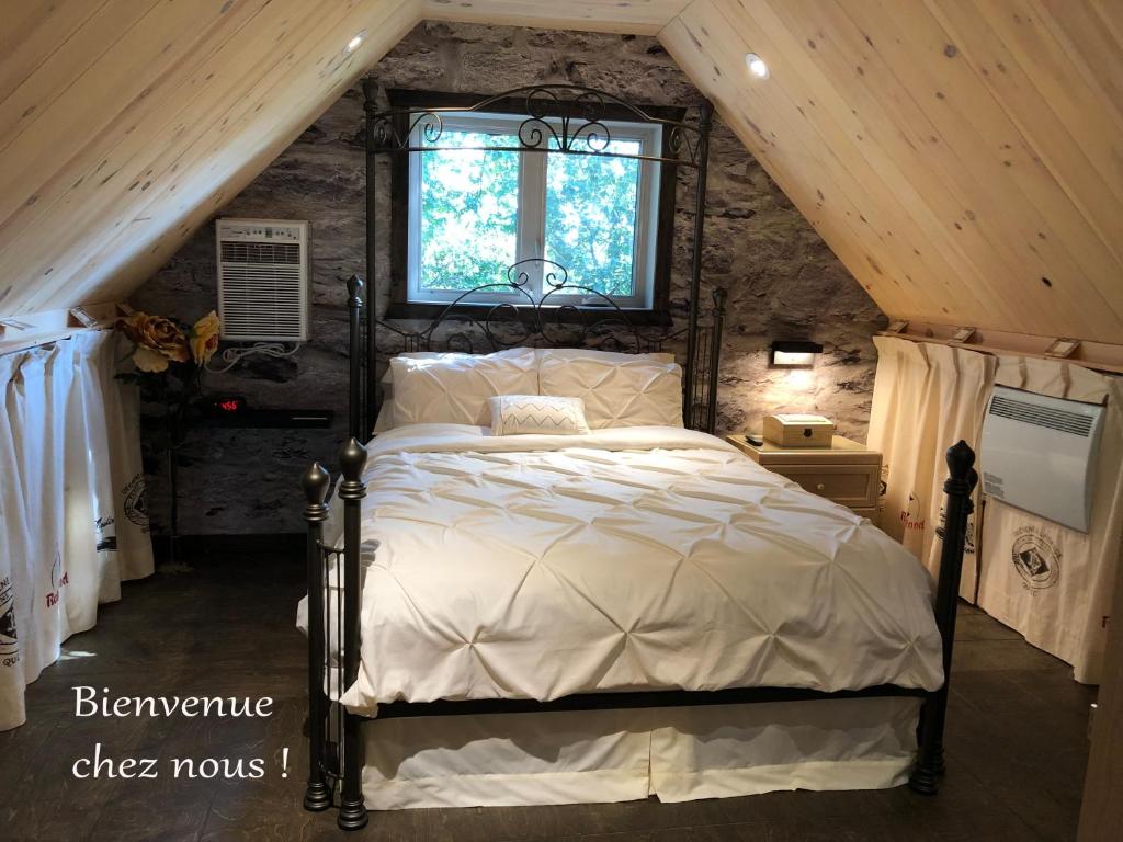 una camera da letto con letto in mansarda di Appartement champêtre a Saguenay