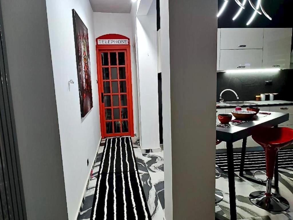 a red phone booth in a room with a kitchen at fruit tower 300Mbps in Thessaloniki