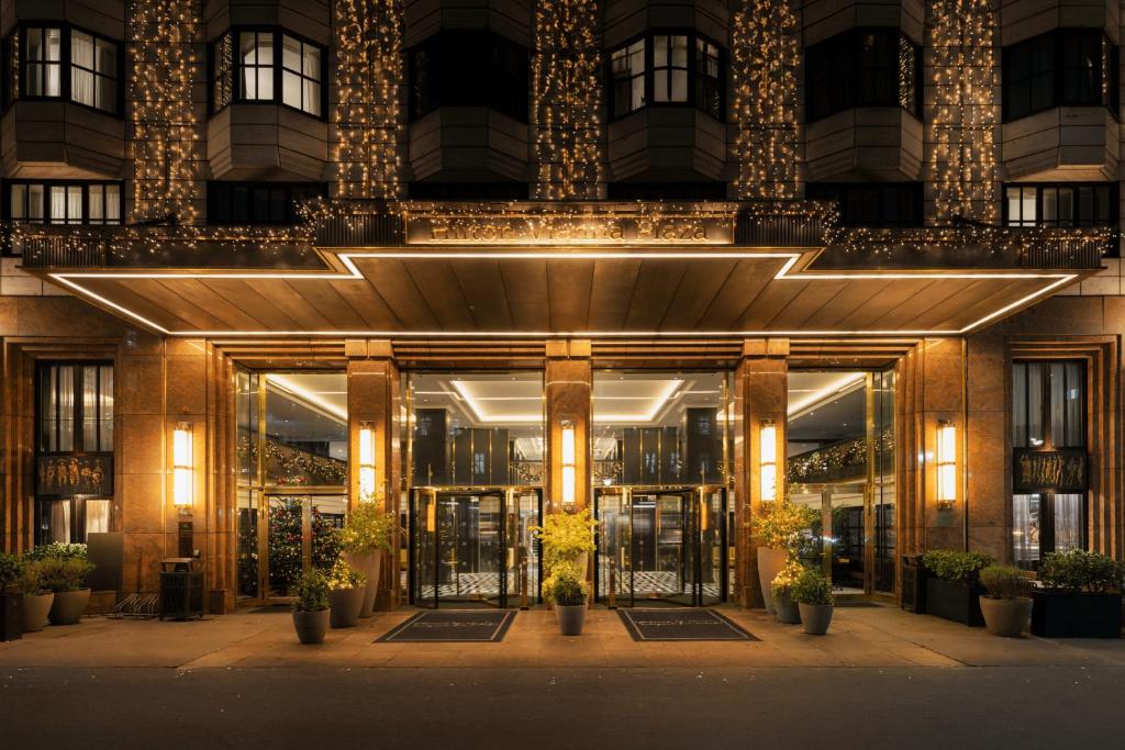 an entrance to a building at night with lights at Hilton Vienna Plaza in Vienna