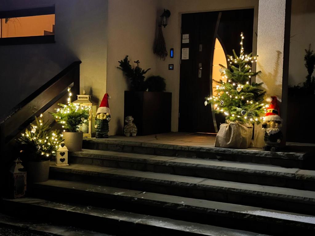 a set of stairs with christmas trees and santa hats at Lawenda in Białka Tatrzanska