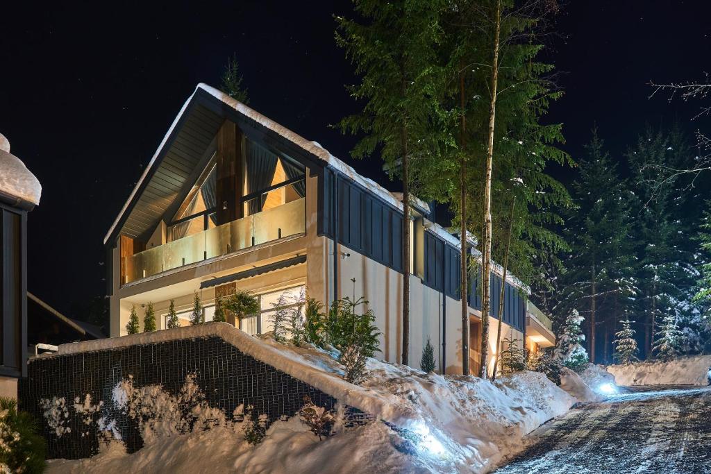 a house that is lit up at night at Buko Village by Fomich in Bukovel