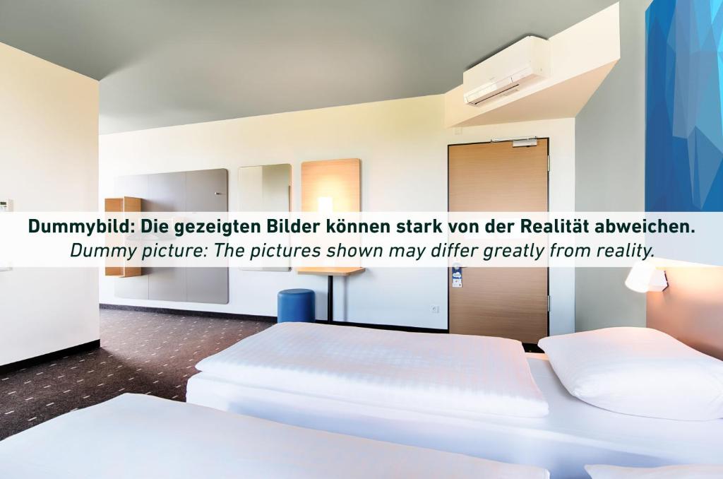 een witte kamer met een wit bed en een poster bij B&B Hotel Bochum Hbf-Süd in Bochum